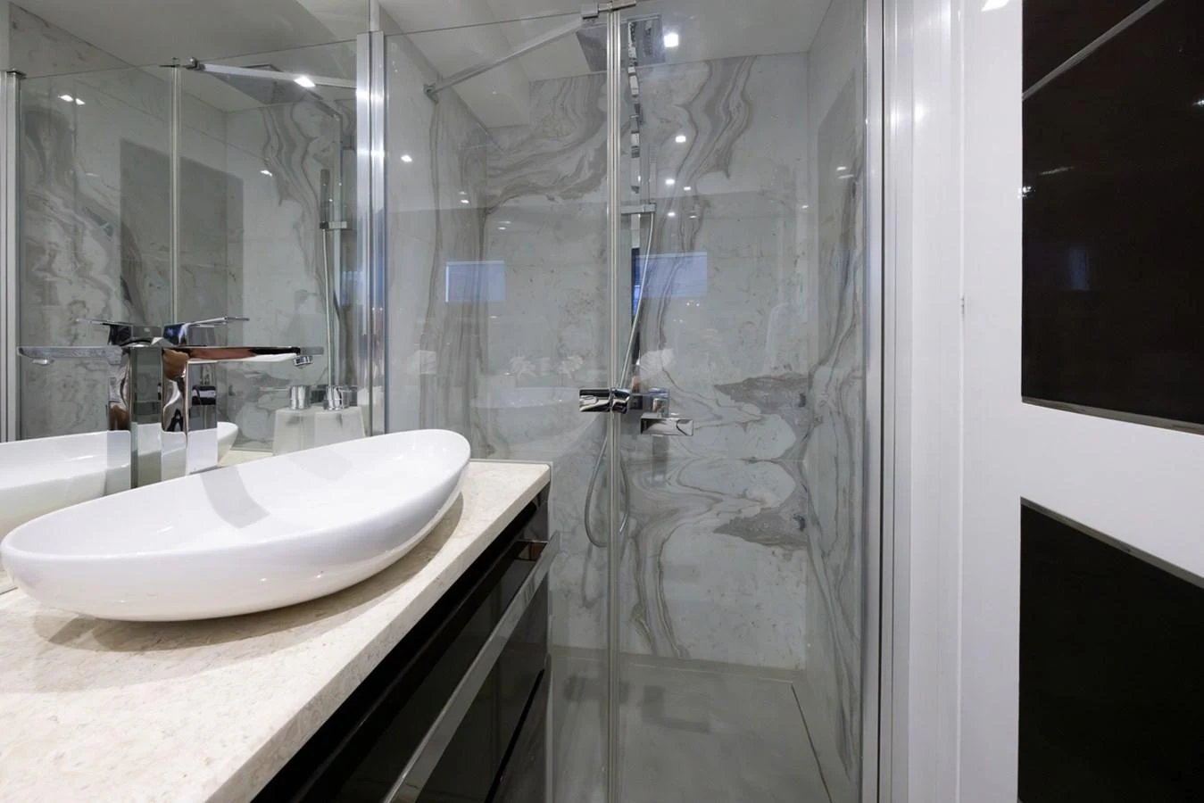a bathroom with a glass shower aboard KANDO Yacht for Sale