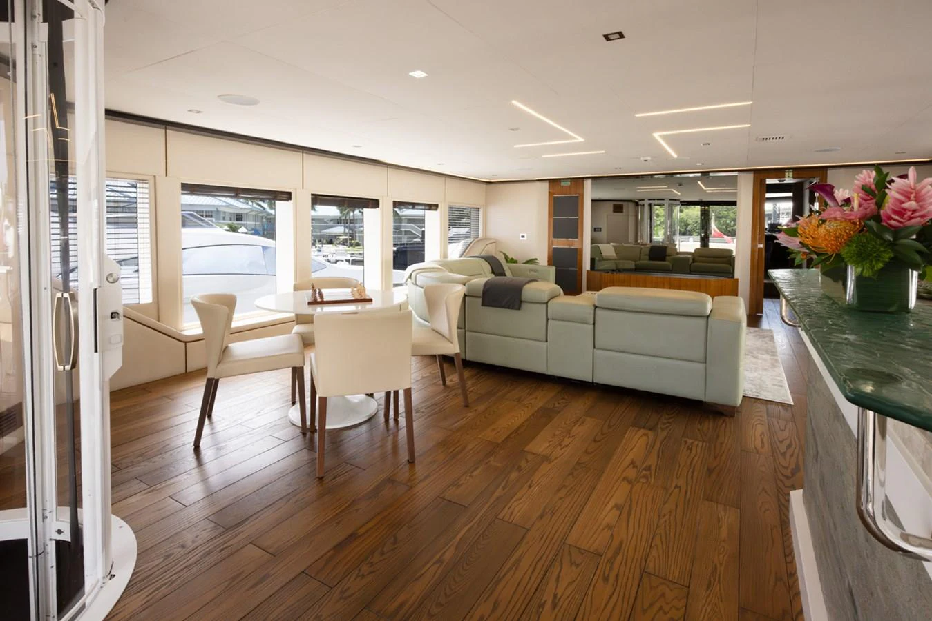 a living room with a table and chairs aboard KANDO Yacht for Sale