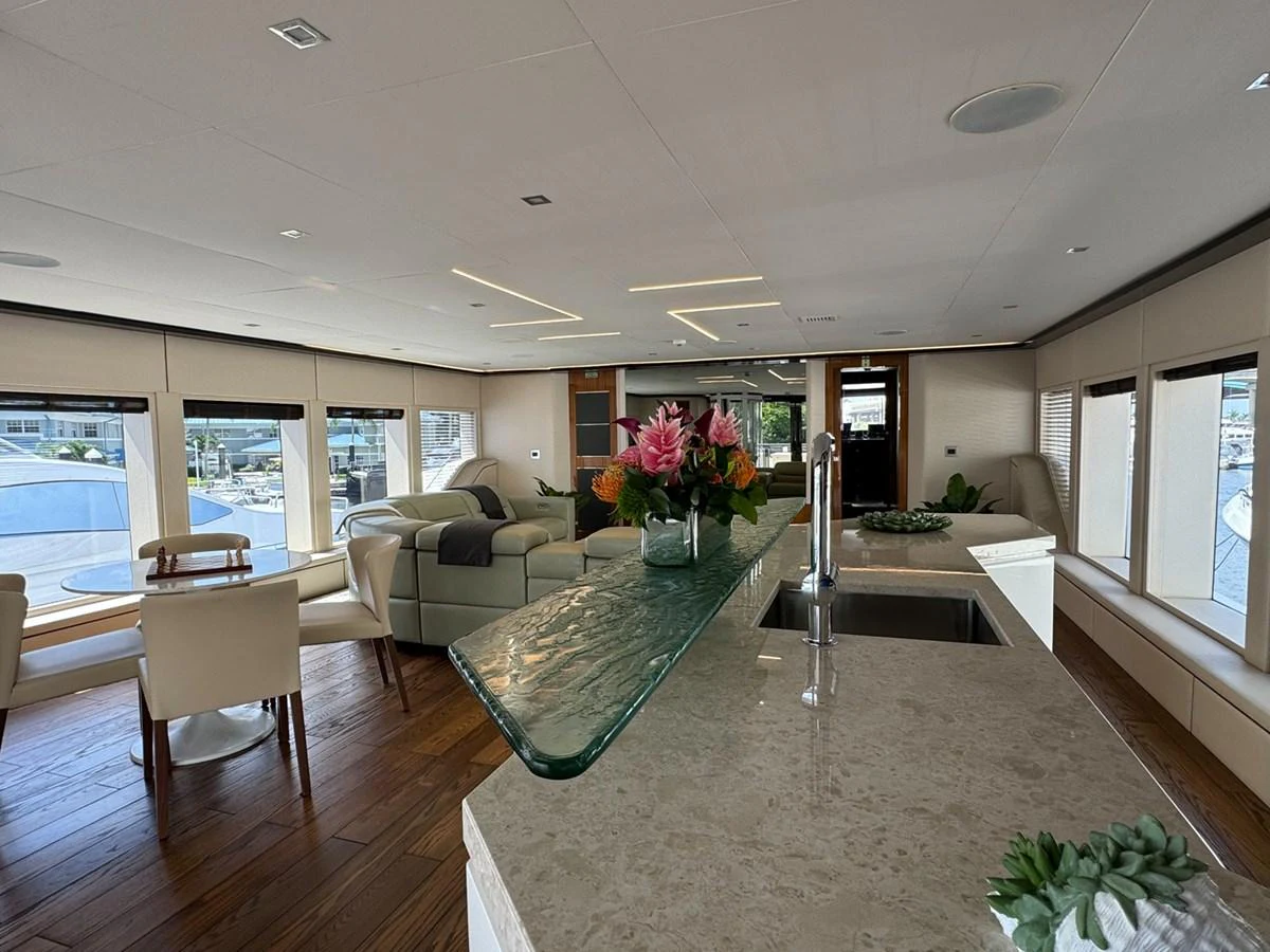 a living room with a table and chairs aboard KANDO Yacht for Sale