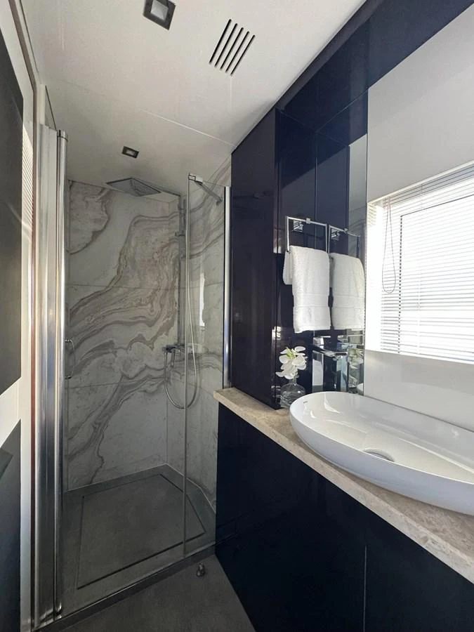 a bathroom with a shower and sink aboard KANDO Yacht for Sale