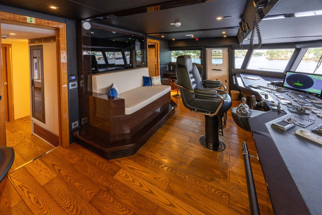a room with a chair and a table and a large mirror aboard KANDO Yacht for Sale