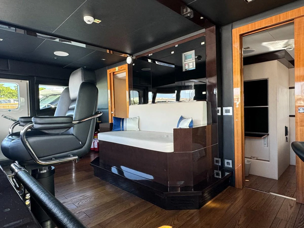 a room with a bed and a couch aboard KANDO Yacht for Sale