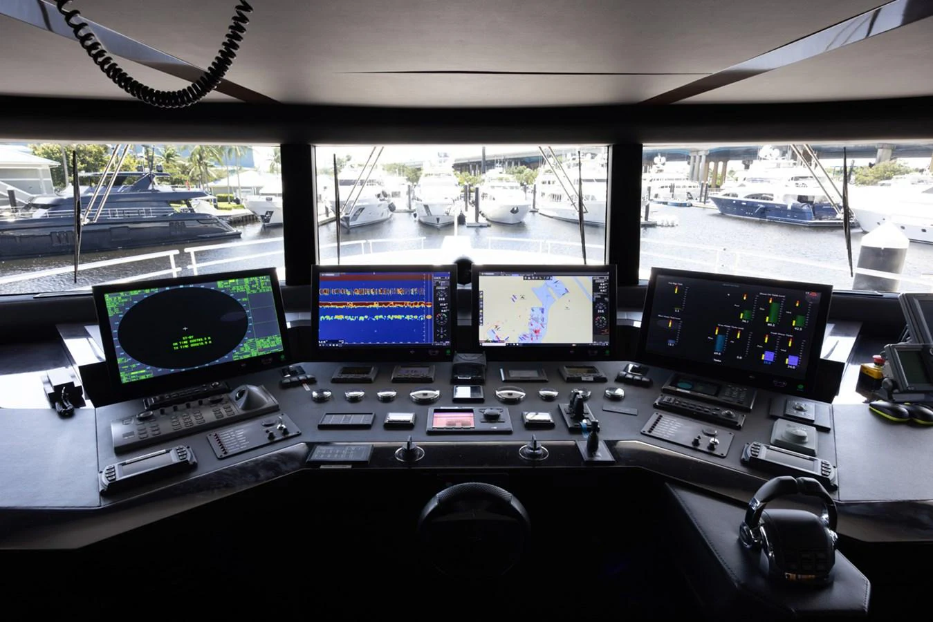 a control panel with multiple monitors aboard KANDO Yacht for Sale