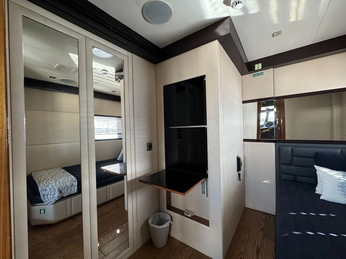 a room with a bed and a desk aboard KANDO Yacht for Sale
