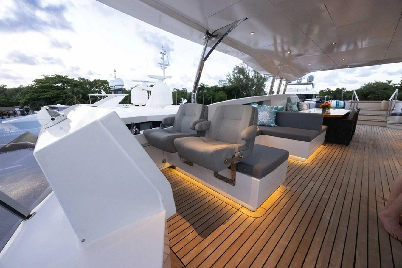 a large living room with a large patio and a large white table aboard KANDO Yacht for Sale