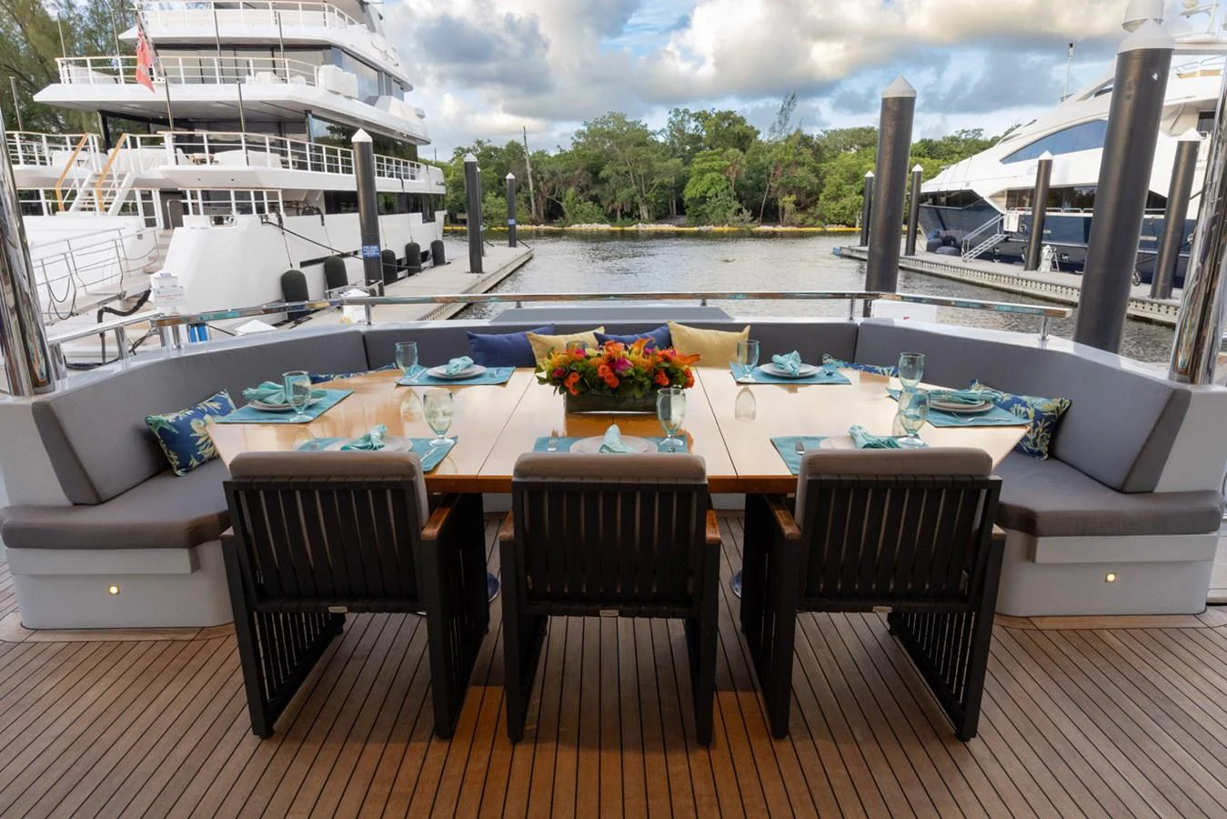 a table and chairs on a deck aboard KANDO Yacht for Sale