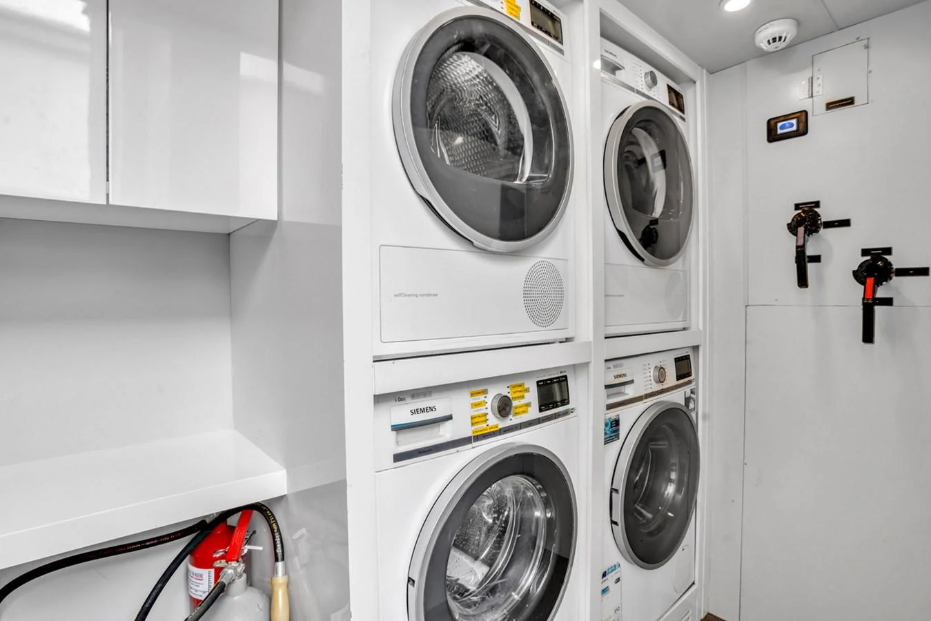 a white laundry room aboard KANDO Yacht for Sale