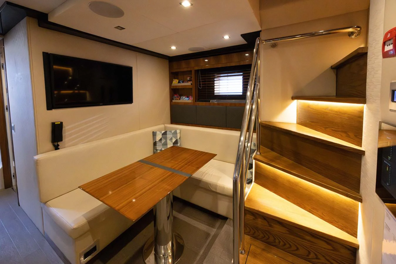 a room with a table and tv aboard KANDO Yacht for Sale