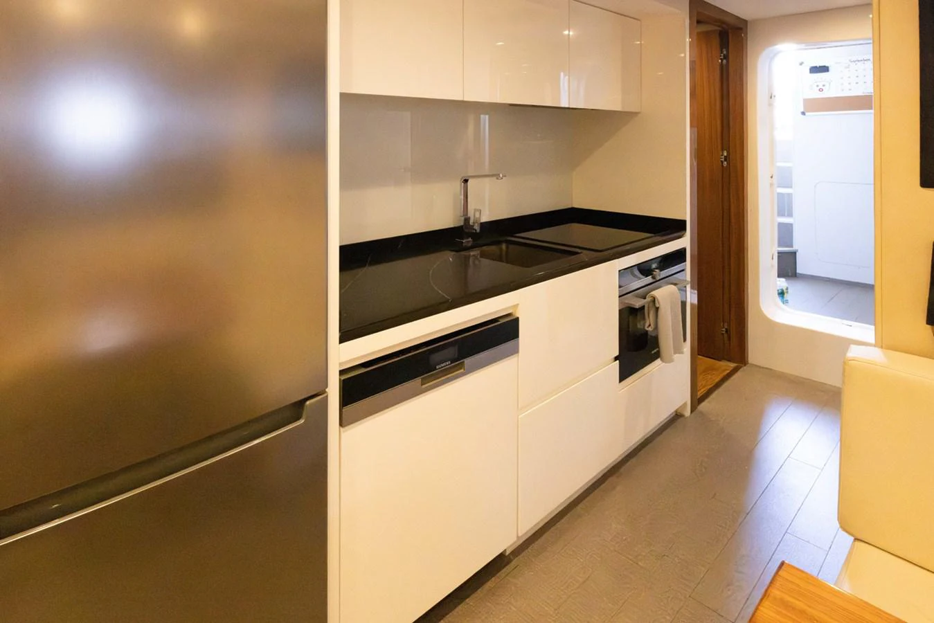 a kitchen with white cabinets aboard KANDO Yacht for Sale
