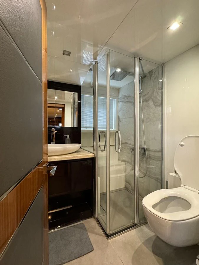 a bathroom with a glass shower aboard KANDO Yacht for Sale