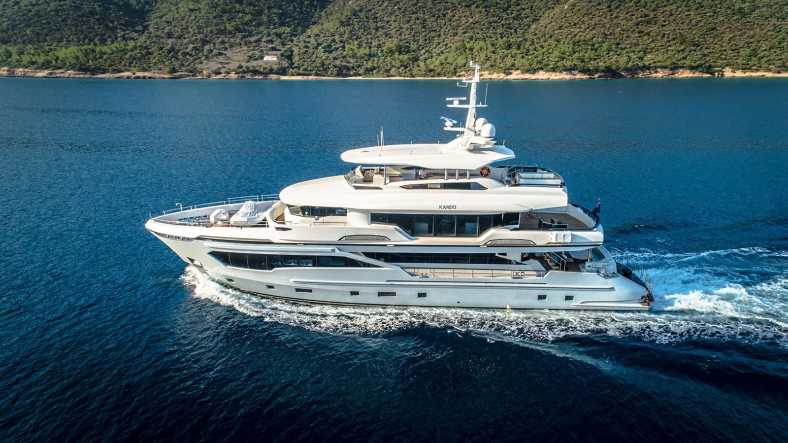 a white yacht on the water aboard KANDO Yacht for Sale