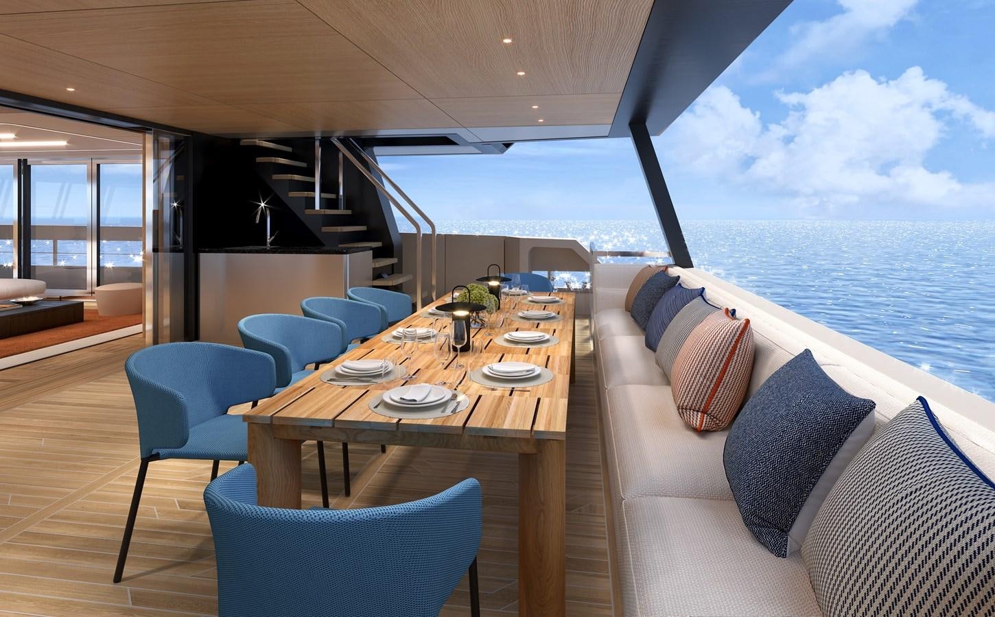 a table with chairs and a couch on a deck overlooking the ocean aboard SILVERCAT SC22M Yacht for Sale