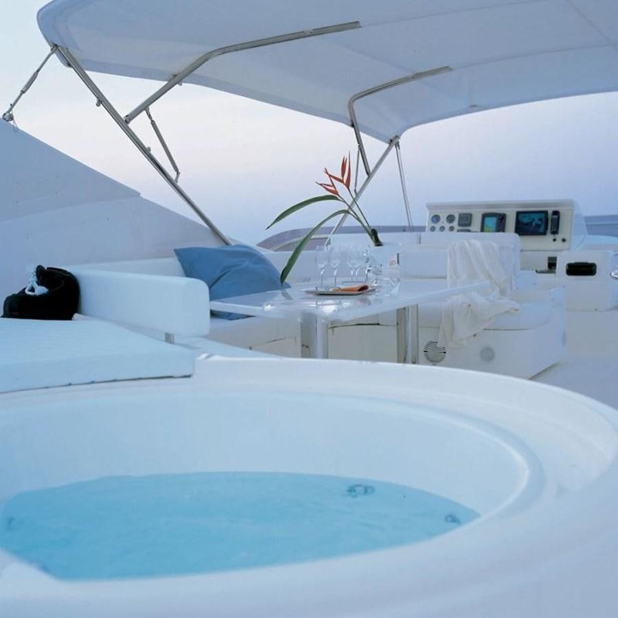 a white room with a white table and chairs aboard NACL Yacht for Sale