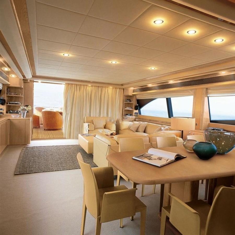 a room with a table and chairs aboard NACL Yacht for Sale