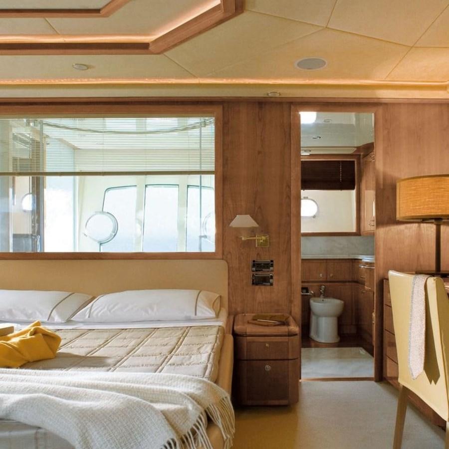 a bedroom with a bed and a mirror aboard NACL Yacht for Sale