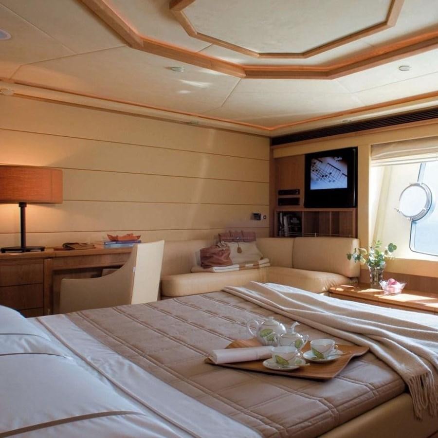 a room with a bed and a television aboard NACL Yacht for Sale