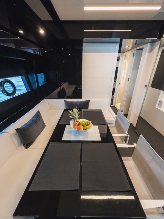 a room with a table and chairs aboard NO Yacht for Sale