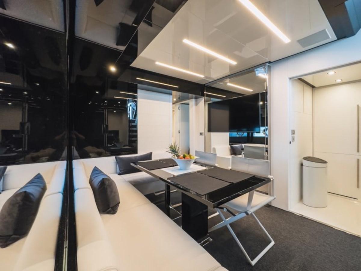 a room with a table and chairs aboard NO Yacht for Sale