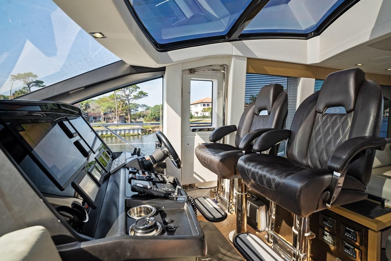 inside of a vehicle with a seat and steering wheel and chairs aboard IT'S A GIRL Yacht for Sale