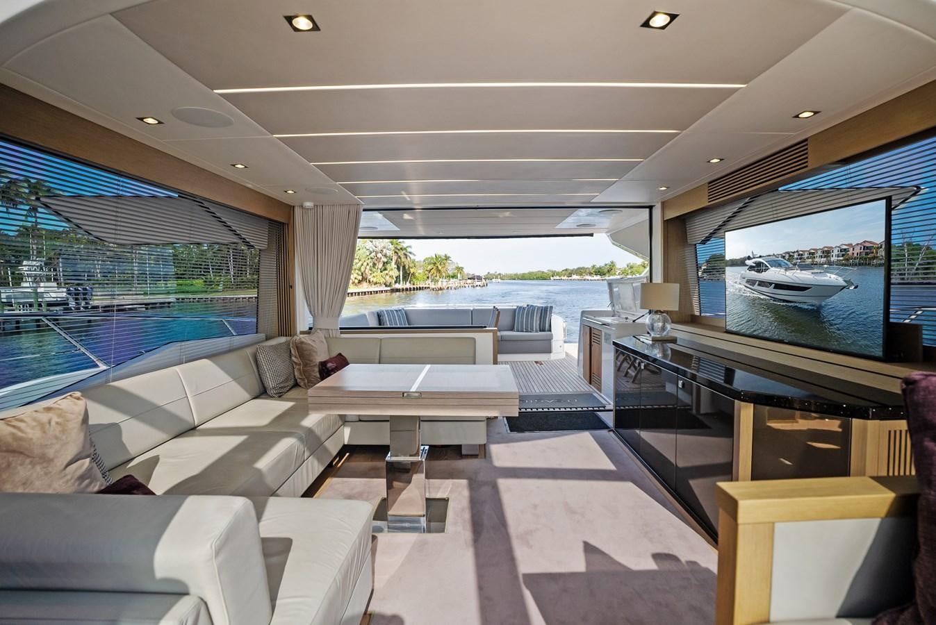 a room with a couch and a table and a large window aboard IT'S A GIRL Yacht for Sale
