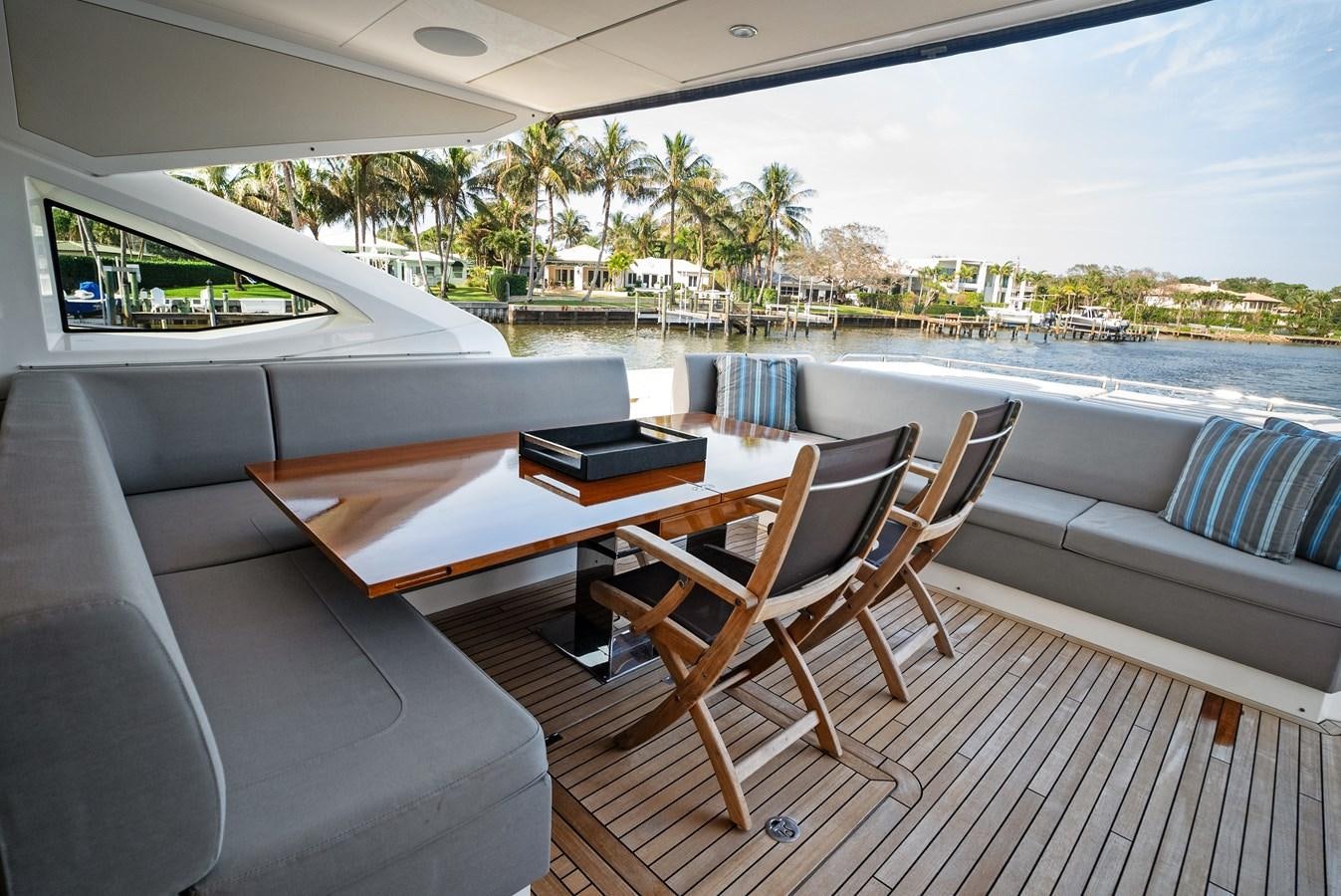 a deck with a table and chairs aboard IT'S A GIRL Yacht for Sale