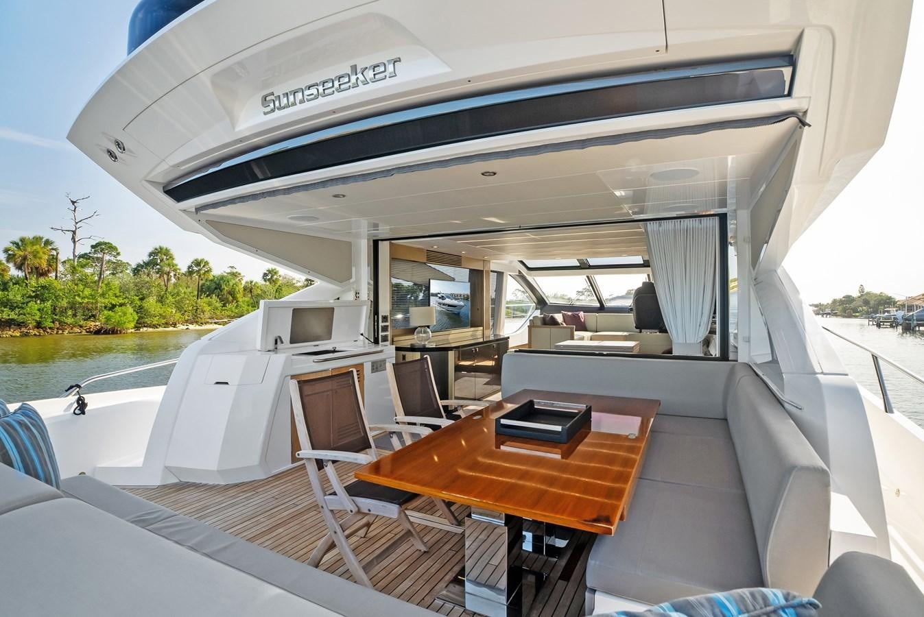 a boat with a table and chairs on it aboard IT'S A GIRL Yacht for Sale