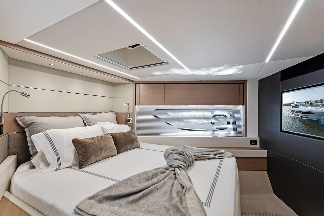a room with a bed and a television aboard IT'S A GIRL Yacht for Sale