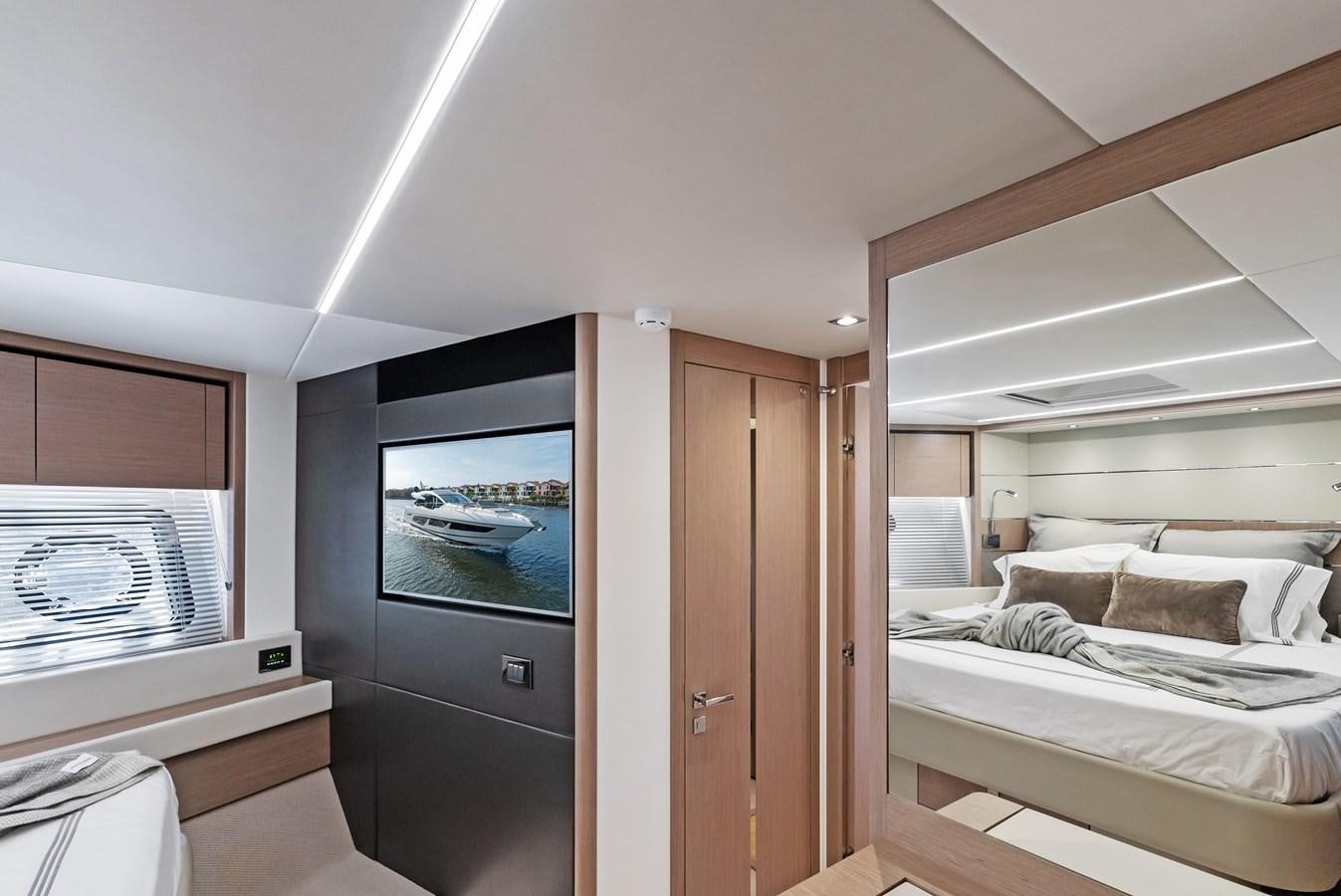 a bedroom with a bed and a television aboard IT'S A GIRL Yacht for Sale