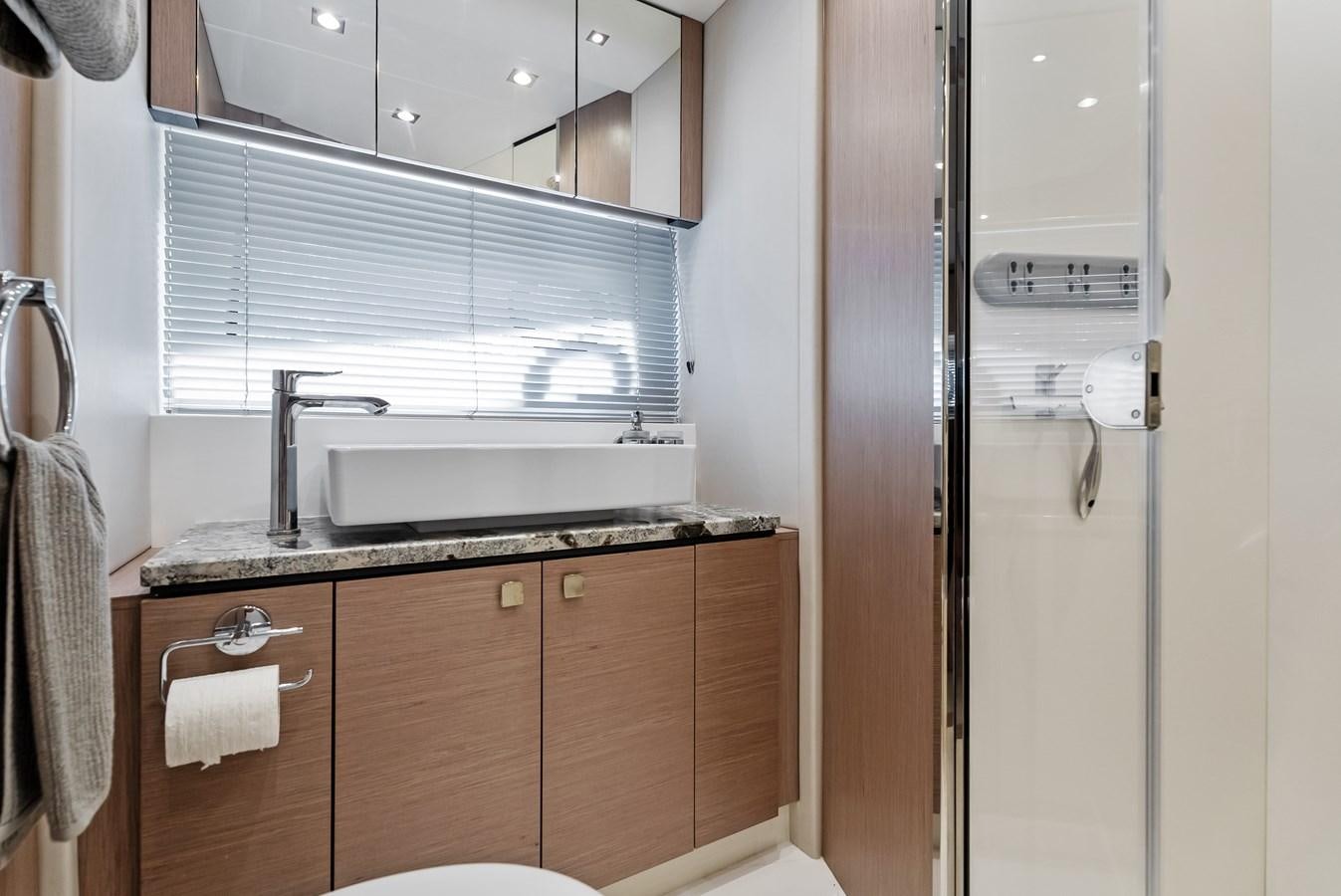 a bathroom with a sink and a mirror aboard IT'S A GIRL Yacht for Sale
