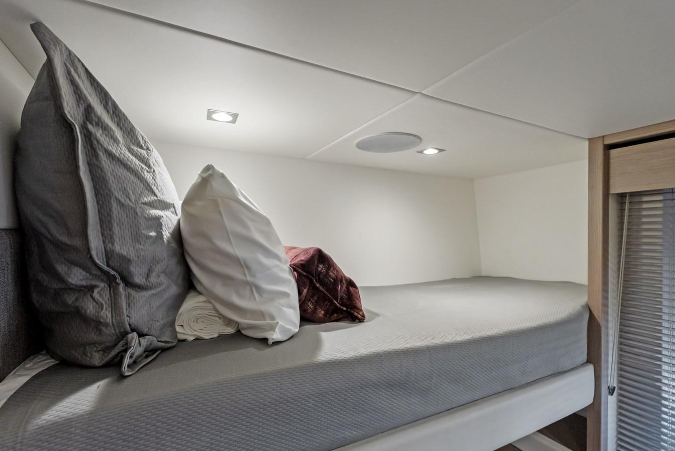 a bed with a white comforter aboard IT'S A GIRL Yacht for Sale