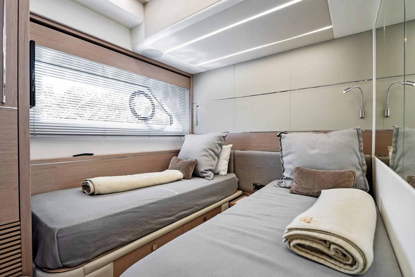 a bed with pillows and a window aboard IT'S A GIRL Yacht for Sale