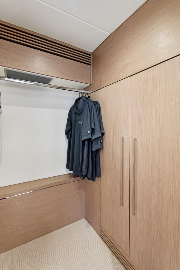 a closet with a blue jacket from the ceiling aboard IT'S A GIRL Yacht for Sale