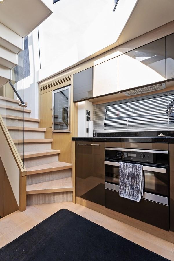 a kitchen with a stove and a window aboard IT'S A GIRL Yacht for Sale