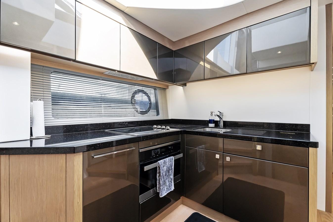 a kitchen with black and white cabinets aboard IT'S A GIRL Yacht for Sale