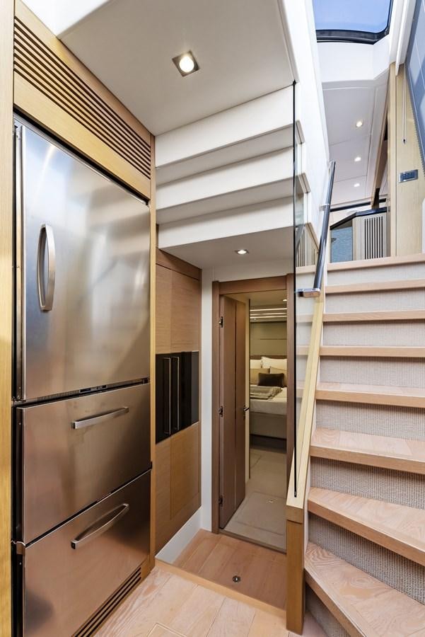 a kitchen with a stainless steel refrigerator aboard IT'S A GIRL Yacht for Sale