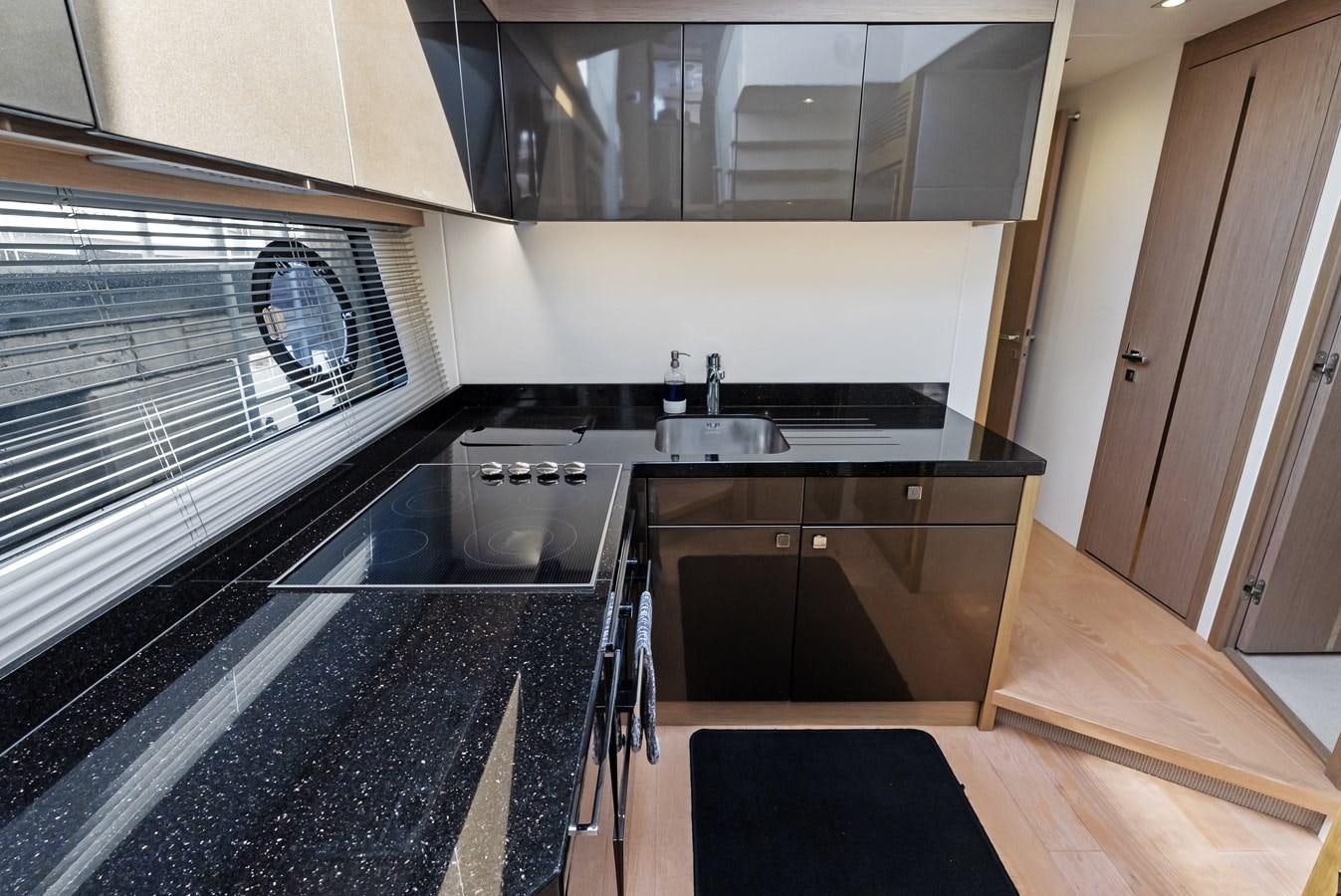 a kitchen with a stainless steel stove aboard IT'S A GIRL Yacht for Sale