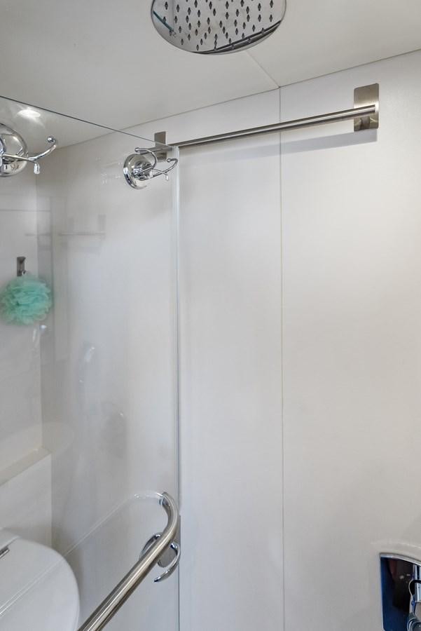 a shower with a blue towel from the ceiling aboard IT'S A GIRL Yacht for Sale