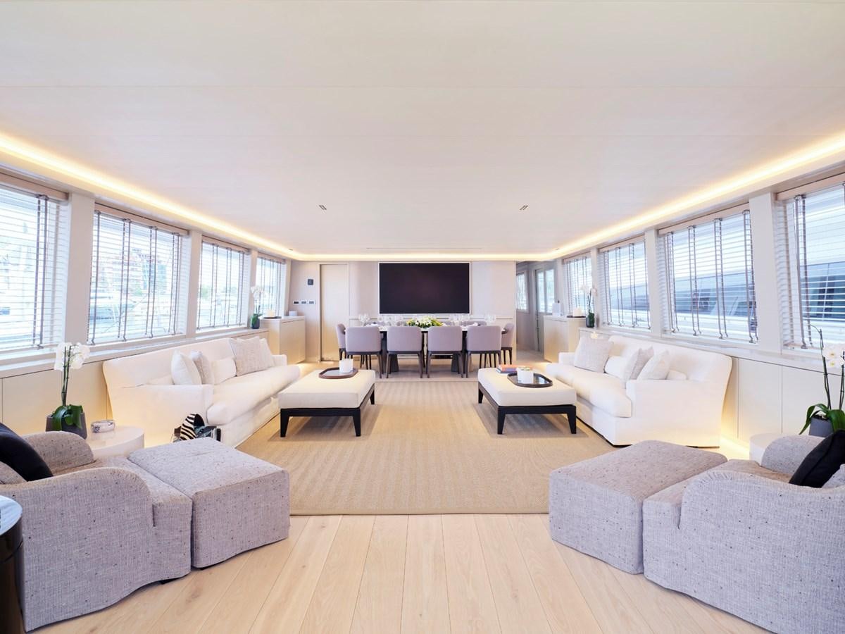 a living room with white couches aboard ENDLESS SUMMER Yacht for Sale