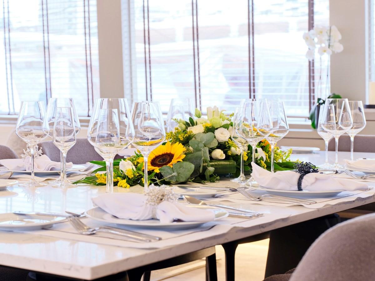 a table set with plates and glasses aboard ENDLESS SUMMER Yacht for Sale