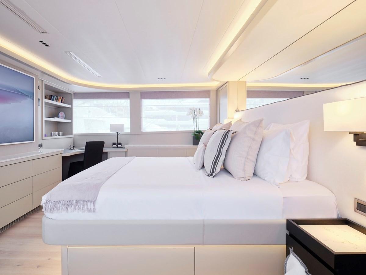 a bedroom with a bed and a desk aboard ENDLESS SUMMER Yacht for Sale