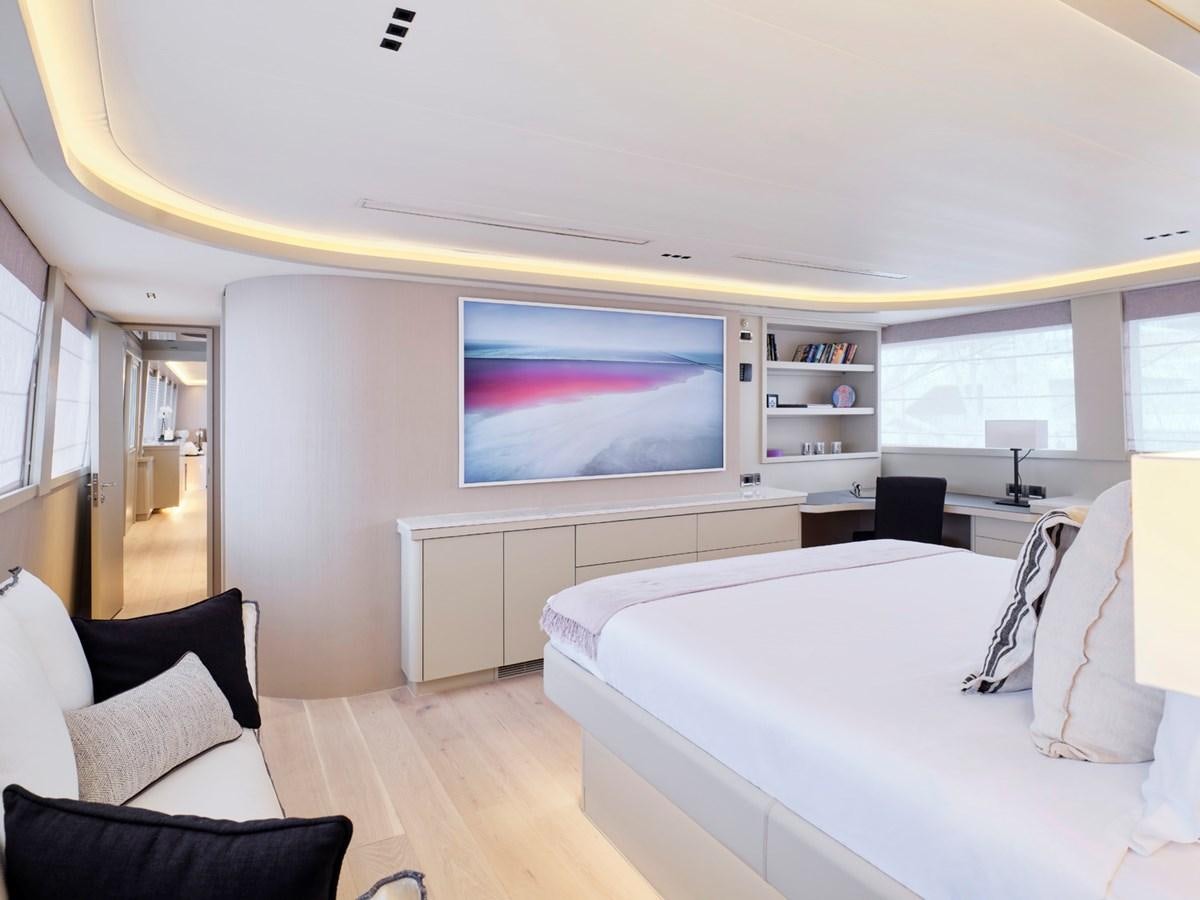 a room with a bed and a tv on the wall aboard ENDLESS SUMMER Yacht for Sale