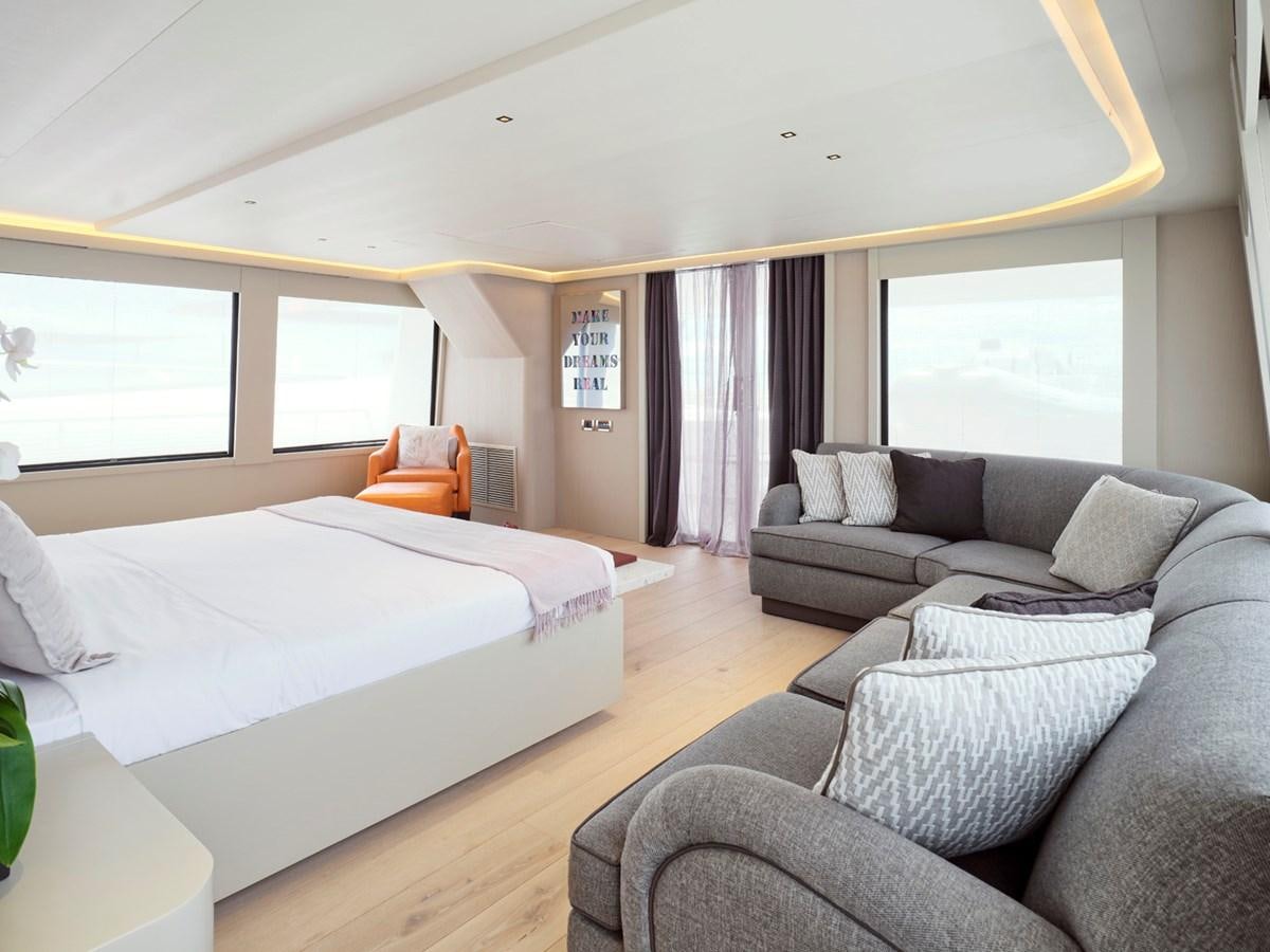 a bedroom with a bed and a couch aboard ENDLESS SUMMER Yacht for Sale