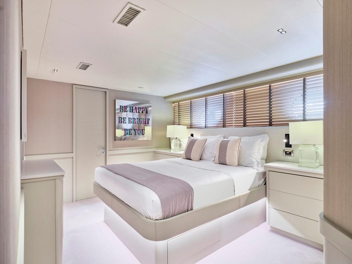 a bedroom with a bed and a window aboard ENDLESS SUMMER Yacht for Sale