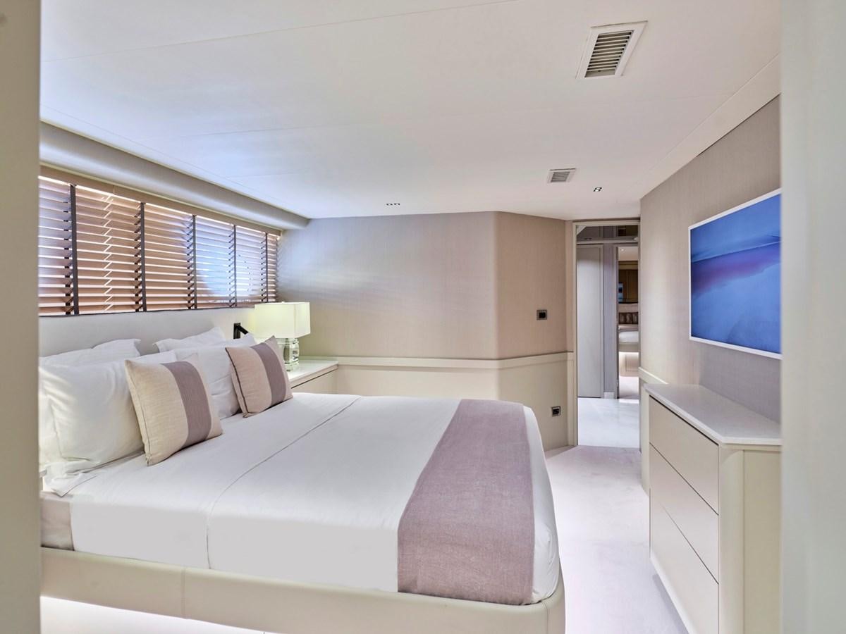a bedroom with a bed and a tv aboard ENDLESS SUMMER Yacht for Sale