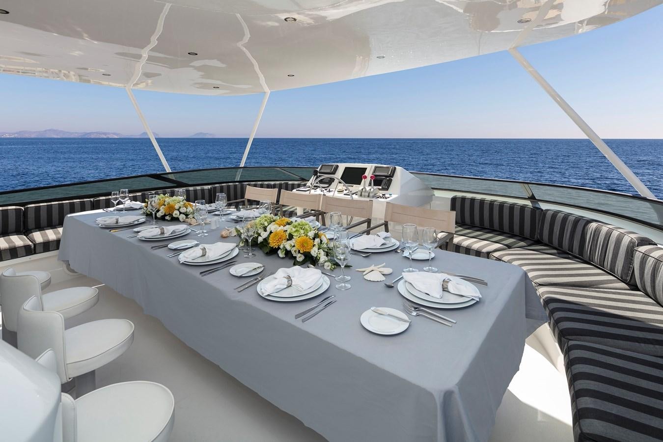 a table set for a dinner on a boat aboard ENDLESS SUMMER Yacht for Sale