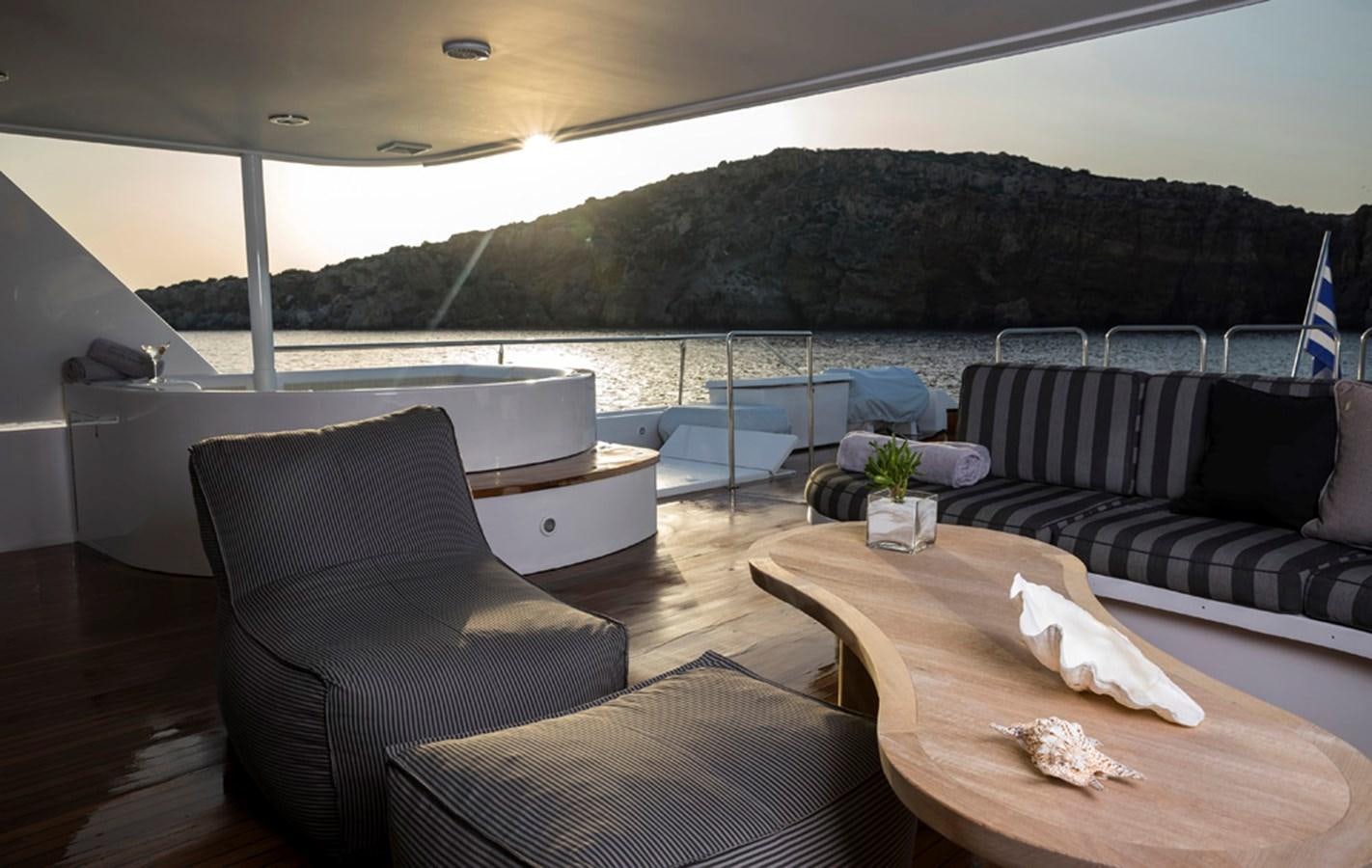 a room with couches and a table and chairs aboard ENDLESS SUMMER Yacht for Sale