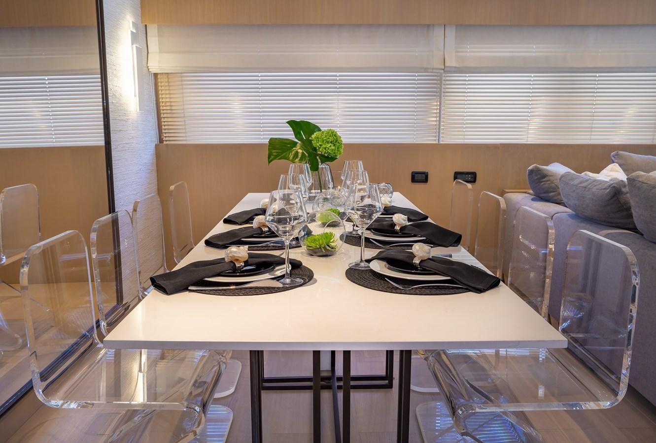 a table with plates and glasses on it aboard SUMMER FUN Yacht for Sale