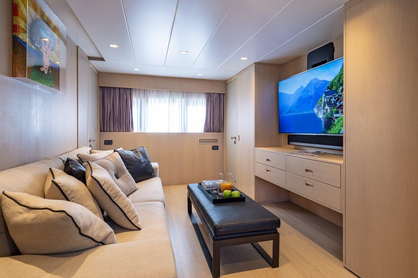 a living room with a tv and furniture aboard SUMMER FUN Yacht for Sale