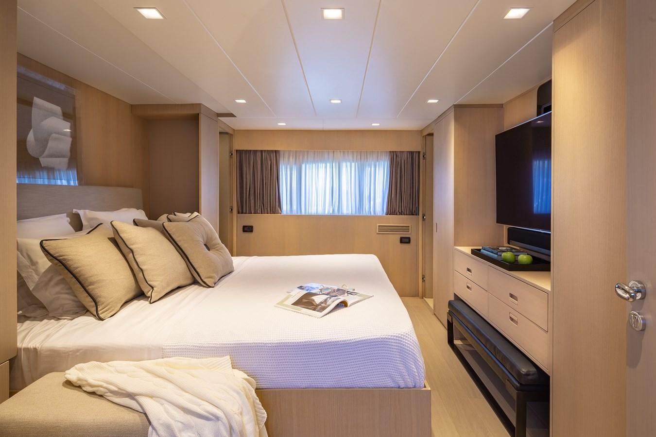 a bedroom with a bed and a television aboard SUMMER FUN Yacht for Sale