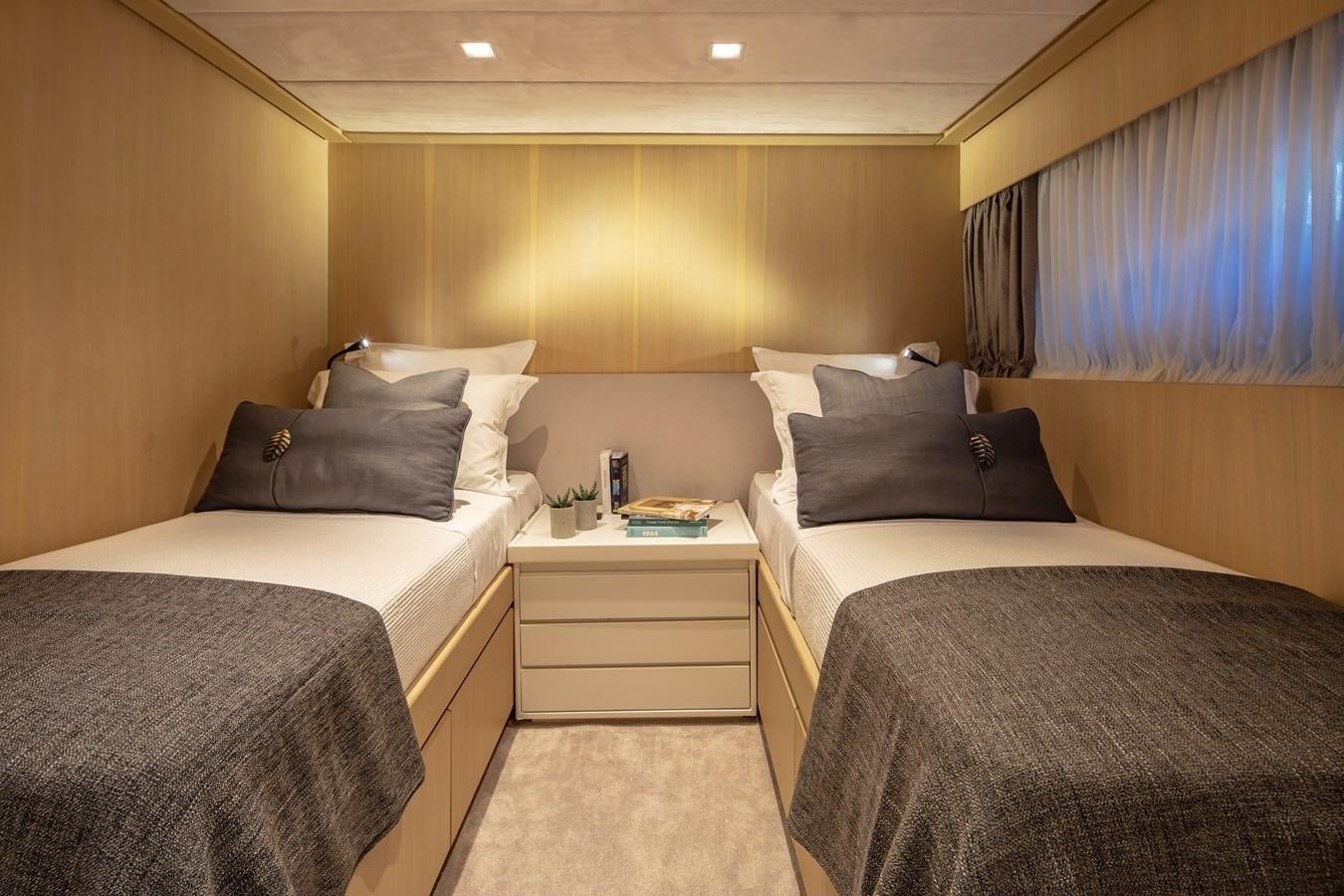 a room with beds and a table aboard SUMMER FUN Yacht for Sale